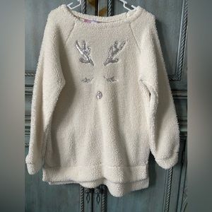 White fleece shirt with silver sequin antlers, eyelashes and nose.